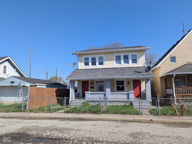 408 E Beecher St, Indianapolis, IN 46225 - view of front of house with covered porch, a gate, and a fenced front yard