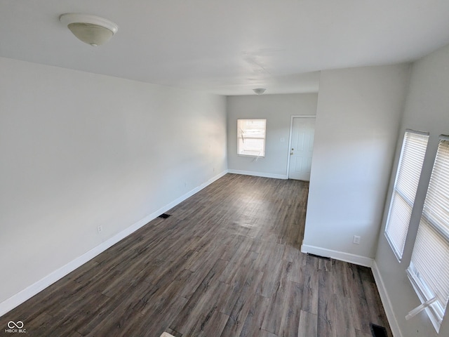 408 E Beecher St, Indianapolis, IN 46225 - spare room featuring dark wood-style floors and baseboards