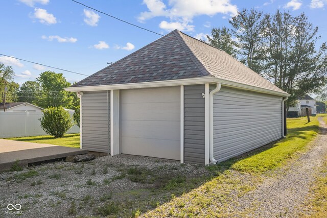 detached garage featuring fence