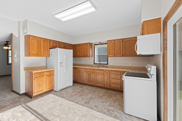 kitchen featuring white appliances, a sink, brown cabinets, and light countertops