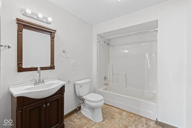 bathroom with toilet, vanity, baseboards, and tub / shower combination