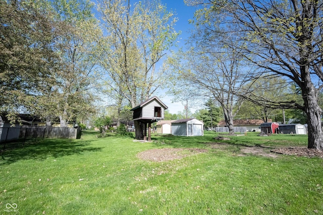 30 Sleepy Hollow Ct, Westfield, IN 46074 - view of yard featuring fence, a storage unit, and an outbuilding