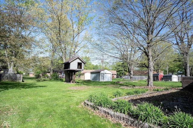 30 Sleepy Hollow Ct, Westfield, IN 46074 - view of yard featuring a storage shed, a detached garage, an outbuilding, and fence