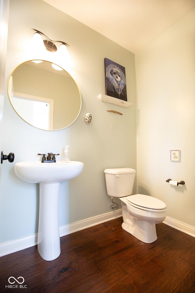 1060 Cape Coral Dr, Cicero, IN 46034 - half bathroom with toilet, wood finished floors, and baseboards