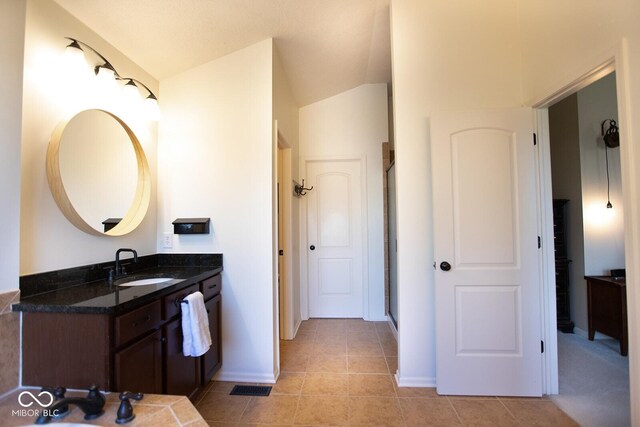 1060 Cape Coral Dr, Cicero, IN 46034 - full bathroom with baseboards, a shower, vanity, vaulted ceiling, and tile patterned flooring
