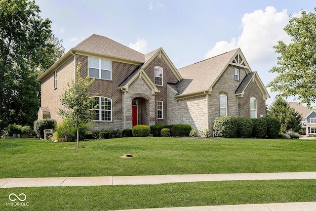 1060 Cape Coral Dr, Cicero, IN 46034 - view of front of house with a front yard, stone siding, and brick siding