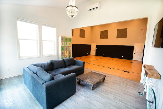 1060 Cape Coral Dr, Cicero, IN 46034 - living room with a chandelier, a wall mounted AC, and wood finished floors