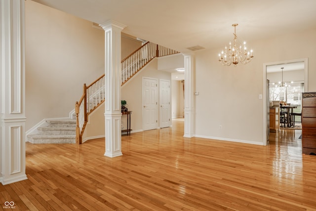 12561 Gladecrest Dr, Carmel, IN 46033 - unfurnished dining area with light wood-type flooring, stairway, a chandelier, and baseboards