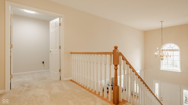 12561 Gladecrest Dr, Carmel, IN 46033 - hall with an upstairs landing, a chandelier, carpet flooring, and baseboards