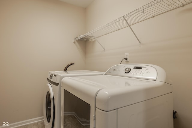 12561 Gladecrest Dr, Carmel, IN 46033 - clothes washing area featuring washing machine and dryer and baseboards
