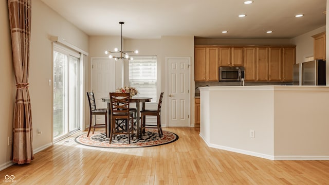 12561 Gladecrest Dr, Carmel, IN 46033 - dining space featuring light wood-style flooring, healthy amount of natural light, recessed lighting, a chandelier, and baseboards