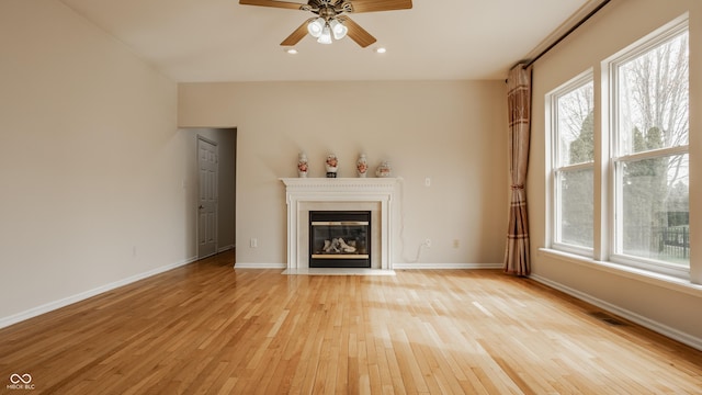 12561 Gladecrest Dr, Carmel, IN 46033 - unfurnished living room featuring light wood-style floors, a ceiling fan, a fireplace with flush hearth, baseboards, and recessed lighting