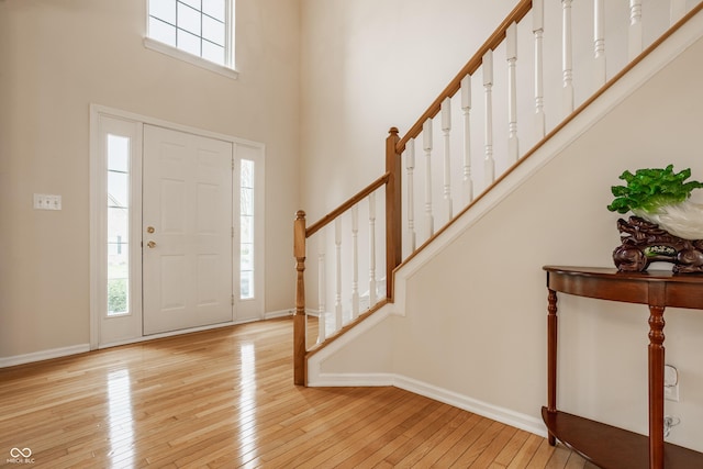 12561 Gladecrest Dr, Carmel, IN 46033 - foyer entrance featuring hardwood / wood-style floors, stairs, a towering ceiling, and baseboards