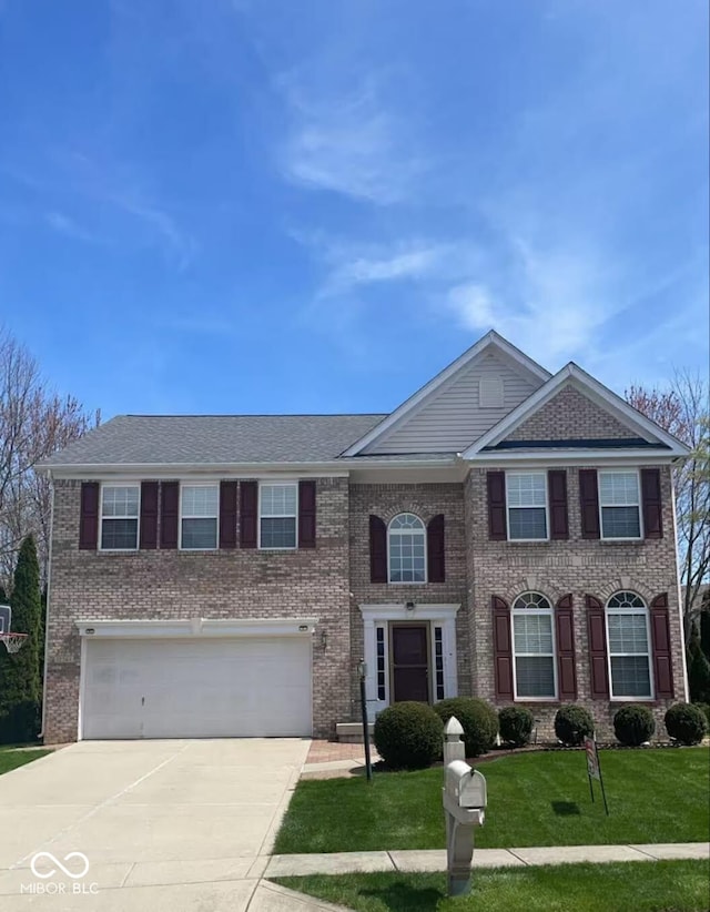 12561 Gladecrest Dr, Carmel, IN 46033 - view of front facade featuring driveway, an attached garage, brick siding, and a front lawn