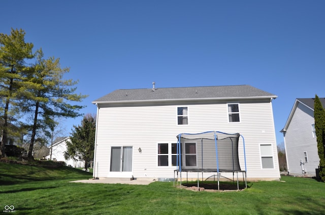 12561 Gladecrest Dr, Carmel, IN 46033 - rear view of property featuring a trampoline and a lawn