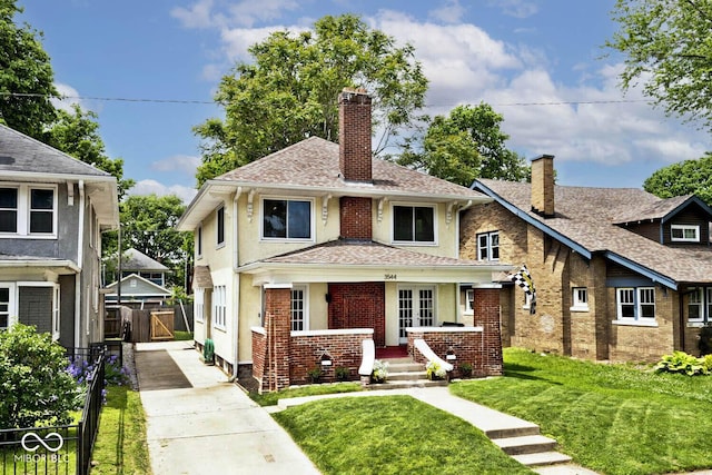 3544 Guilford Ave, Indianapolis, IN 46205 - view of front of property with a chimney, concrete driveway, brick siding, roof with shingles, and stucco siding