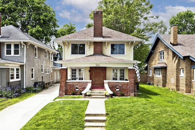 3544 Guilford Ave, Indianapolis, IN 46205 - view of front of home featuring a chimney, a shingled roof, and brick siding