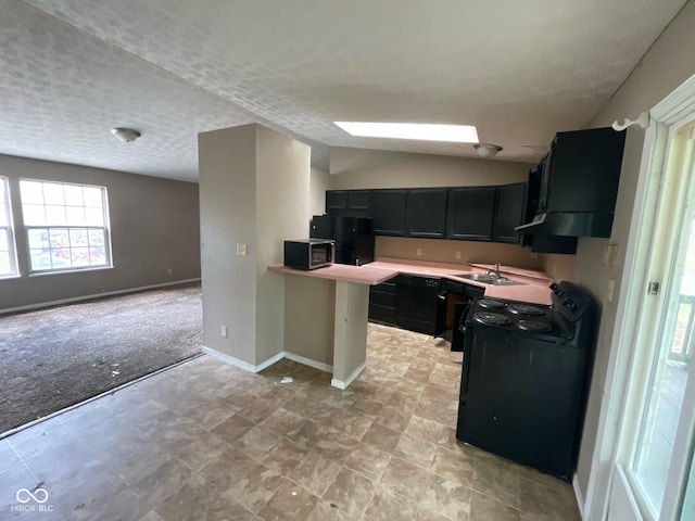 kitchen featuring dark cabinets, light countertops, a sink, baseboards, and black appliances