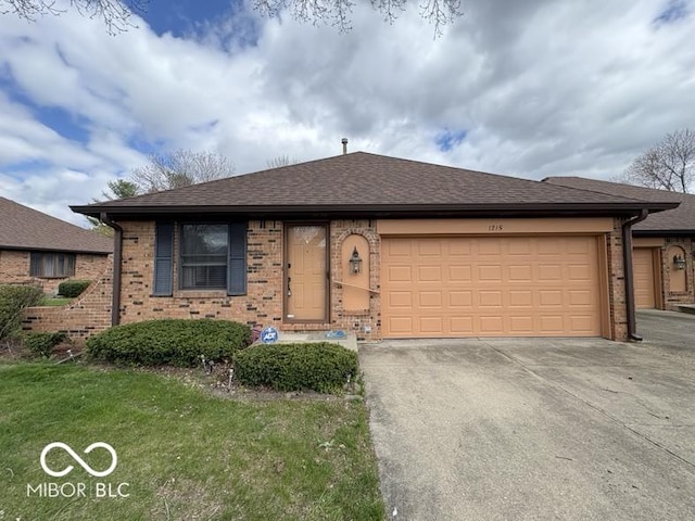 1215 Willow Springs Blvd, Brownsburg, IN 46112 - view of front of home with an attached garage, driveway, brick siding, and roof with shingles