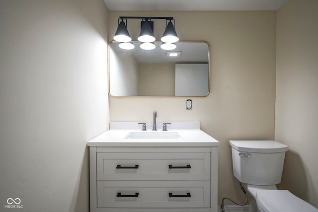 bathroom featuring toilet and vanity