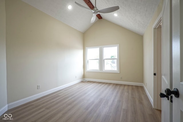empty room with light wood-style floors, baseboards, recessed lighting, a ceiling fan, and vaulted ceiling