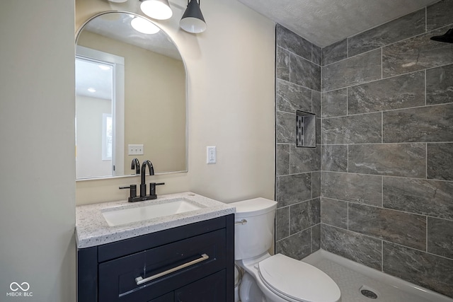 full bath with vanity, a stall shower, and toilet