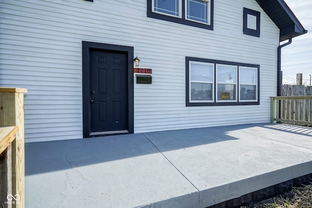 view of exterior entry featuring a patio area