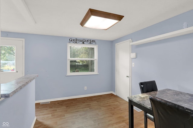 home office featuring visible vents, baseboards, and light wood-style floors