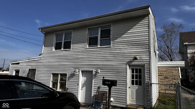 back of house with fence
