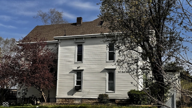 view of home's exterior featuring a chimney