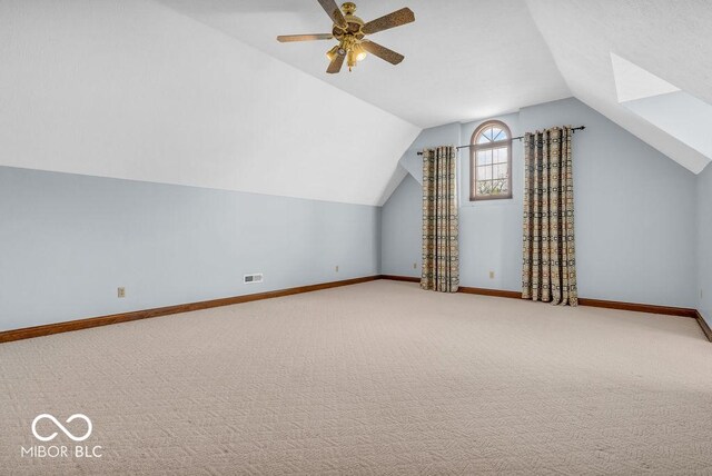 7113 Lakeside Woods Dr, Indianapolis, IN 46278 - additional living space with carpet floors, lofted ceiling, baseboards, and ceiling fan