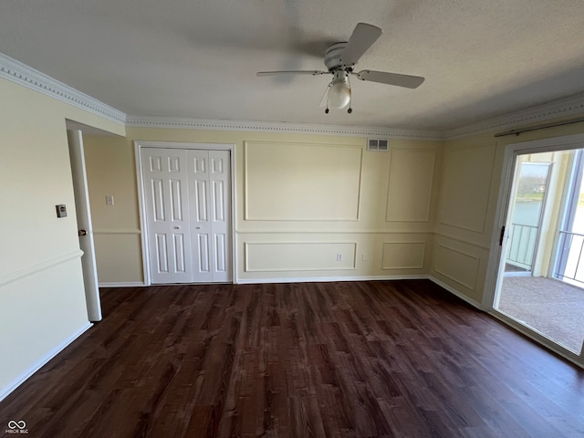 unfurnished bedroom featuring dark wood finished floors, access to exterior, visible vents, a ceiling fan, and crown molding