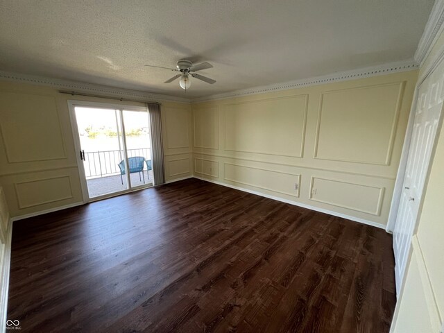 unfurnished room featuring dark wood finished floors, ornamental molding, a ceiling fan, and a decorative wall
