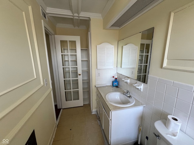 bathroom featuring vanity, tile patterned floors, toilet, visible vents, and ornamental molding
