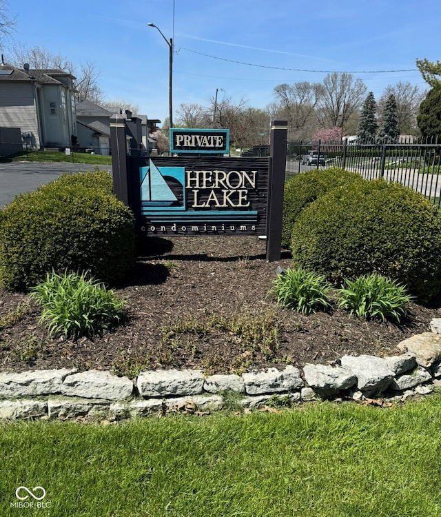 community / neighborhood sign with fence