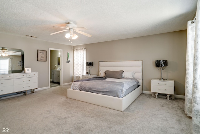 10597 Cyrus Dr, Indianapolis, IN 46231 - carpeted bedroom with baseboards, ensuite bath, ceiling fan, and a textured ceiling