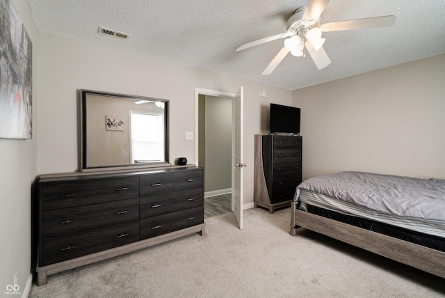 10597 Cyrus Dr, Indianapolis, IN 46231 - bedroom with light carpet, a textured ceiling, a ceiling fan, and baseboards