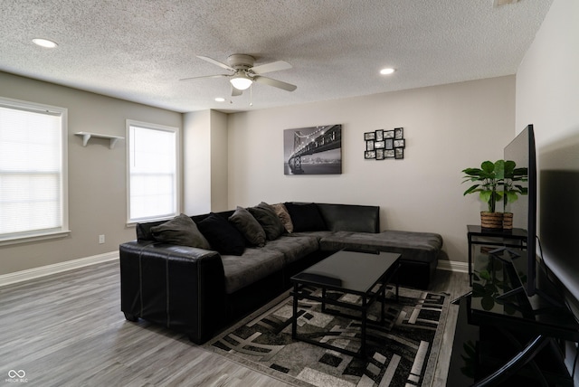 10597 Cyrus Dr, Indianapolis, IN 46231 - living area featuring wood finished floors, a ceiling fan, recessed lighting, baseboards, and a textured ceiling