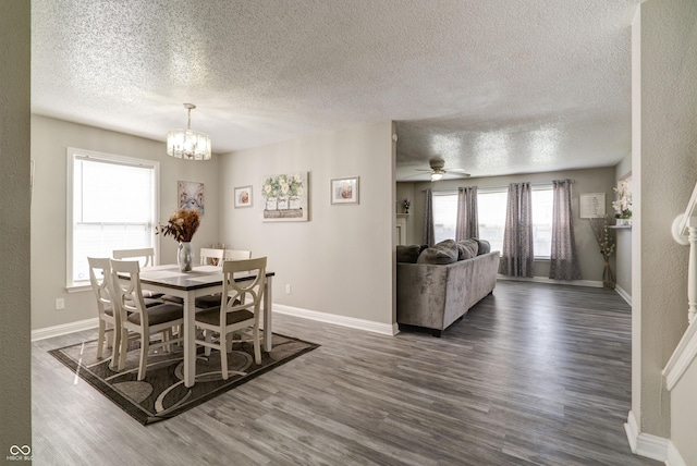 10597 Cyrus Dr, Indianapolis, IN 46231 - dining area featuring a textured ceiling, dark wood-style flooring, a chandelier, and baseboards