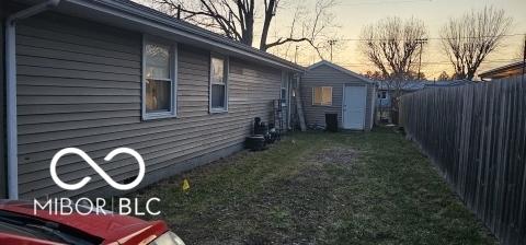 view of home's exterior featuring a yard and fence