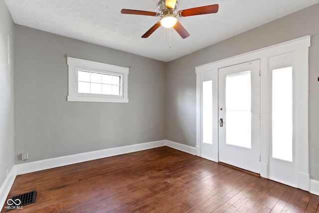 67 S 9th Ave, Beech Grove, IN 46107 - foyer entrance featuring dark wood finished floors, baseboards, ceiling fan, and visible vents