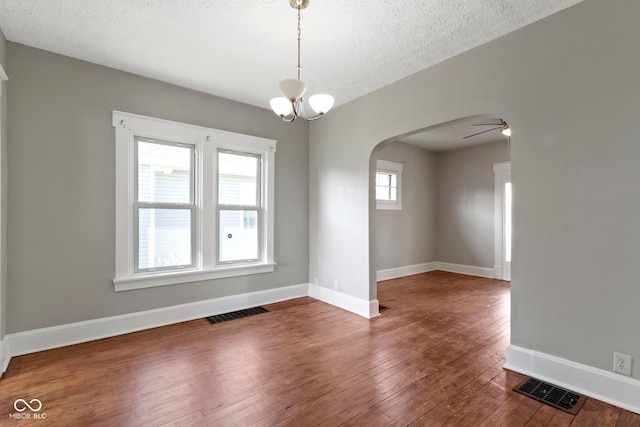 67 S 9th Ave, Beech Grove, IN 46107 - empty room with wood-type flooring, arched walkways, visible vents, and baseboards