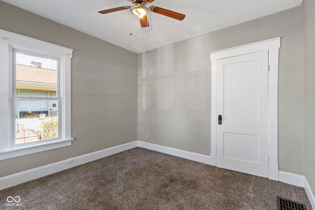 67 S 9th Ave, Beech Grove, IN 46107 - spare room featuring a ceiling fan, a textured ceiling, carpet floors, baseboards, and visible vents