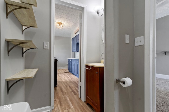 67 S 9th Ave, Beech Grove, IN 46107 - hallway with baseboards, a textured ceiling, and light wood-style floors