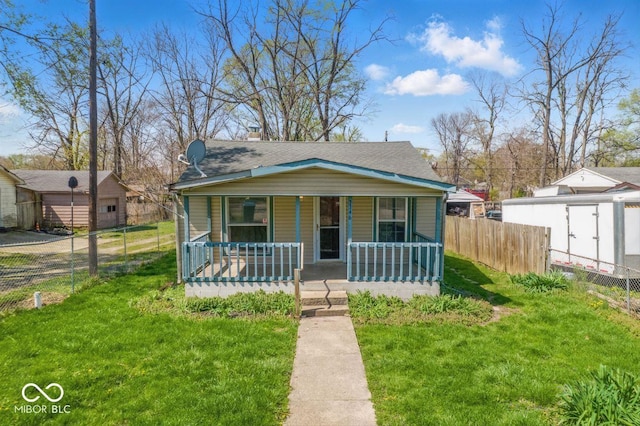 3346 S Lockburn St, Indianapolis, IN 46221 - bungalow featuring a shingled roof, covered porch, a front yard, and fence