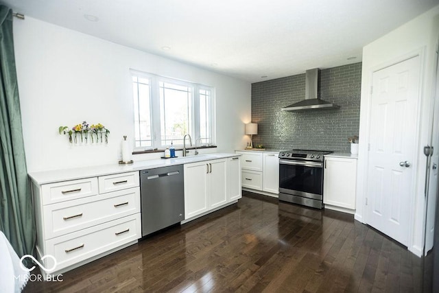 3896 Woods Bay Ln, Plainfield, IN 46168 - kitchen featuring wall chimney range hood, decorative backsplash, appliances with stainless steel finishes, dark wood finished floors, and a sink