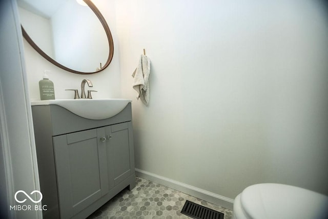 3896 Woods Bay Ln, Plainfield, IN 46168 - bathroom with baseboards, visible vents, toilet, and vanity
