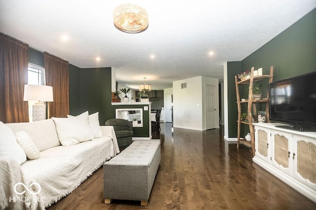 3896 Woods Bay Ln, Plainfield, IN 46168 - living area featuring an inviting chandelier, recessed lighting, baseboards, visible vents, and dark wood-style floors