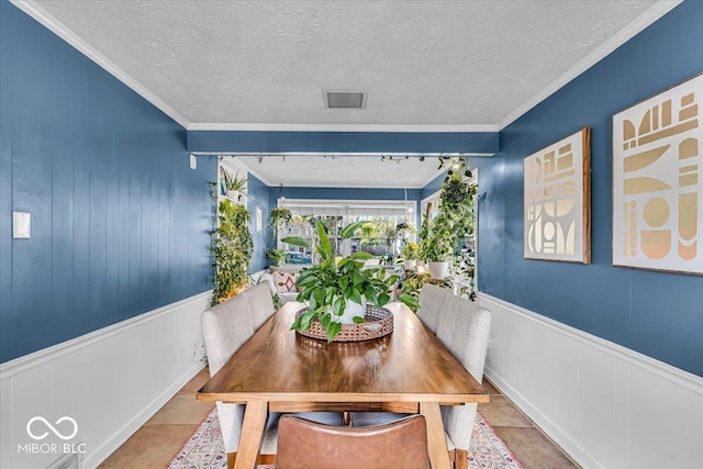 2204 Pamela Dr, Indianapolis, IN 46220 - dining space with a wainscoted wall, a textured ceiling, and crown molding