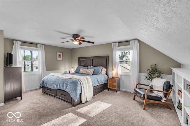 2204 Pamela Dr, Indianapolis, IN 46220 - carpeted bedroom with a textured ceiling, a wainscoted wall, and multiple windows